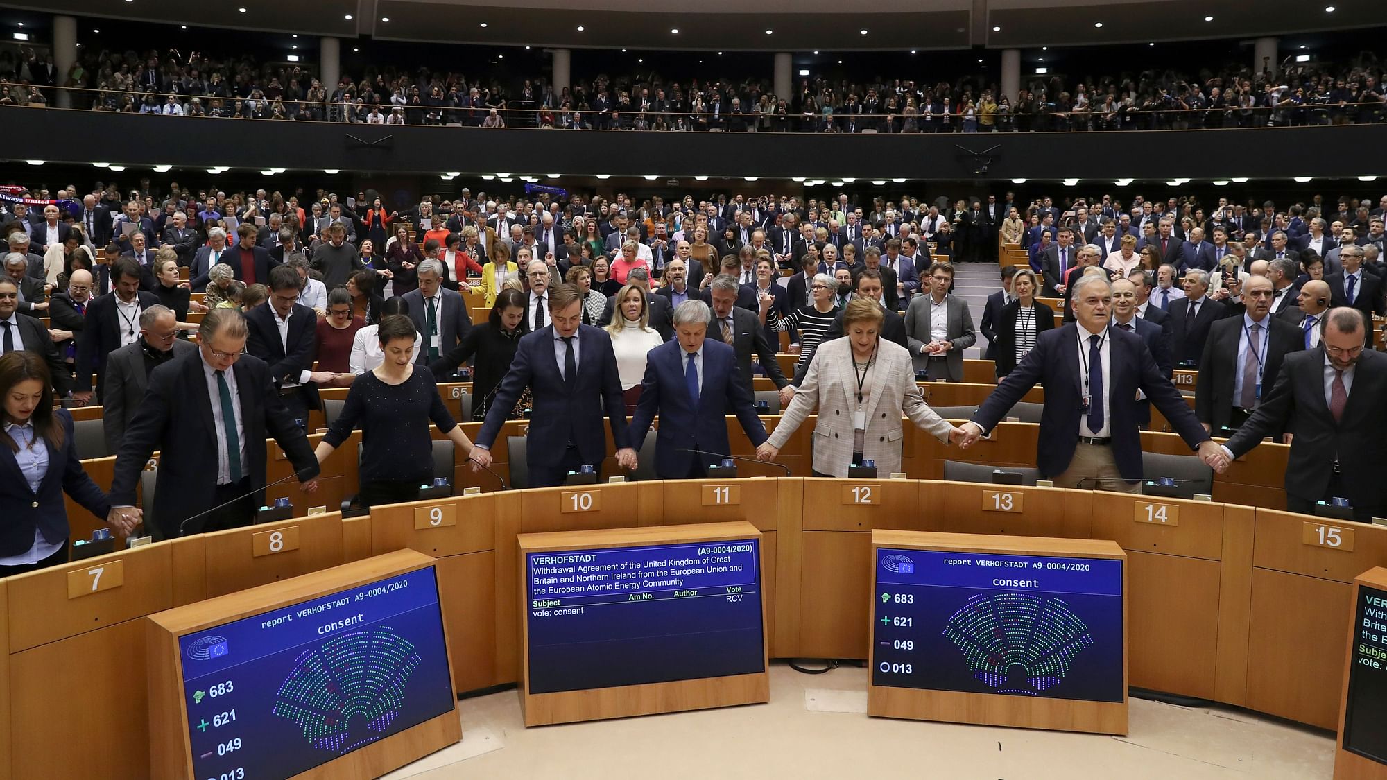 MEPs sing and hold hands after a vote on the UK’s withdrawal from the EU.