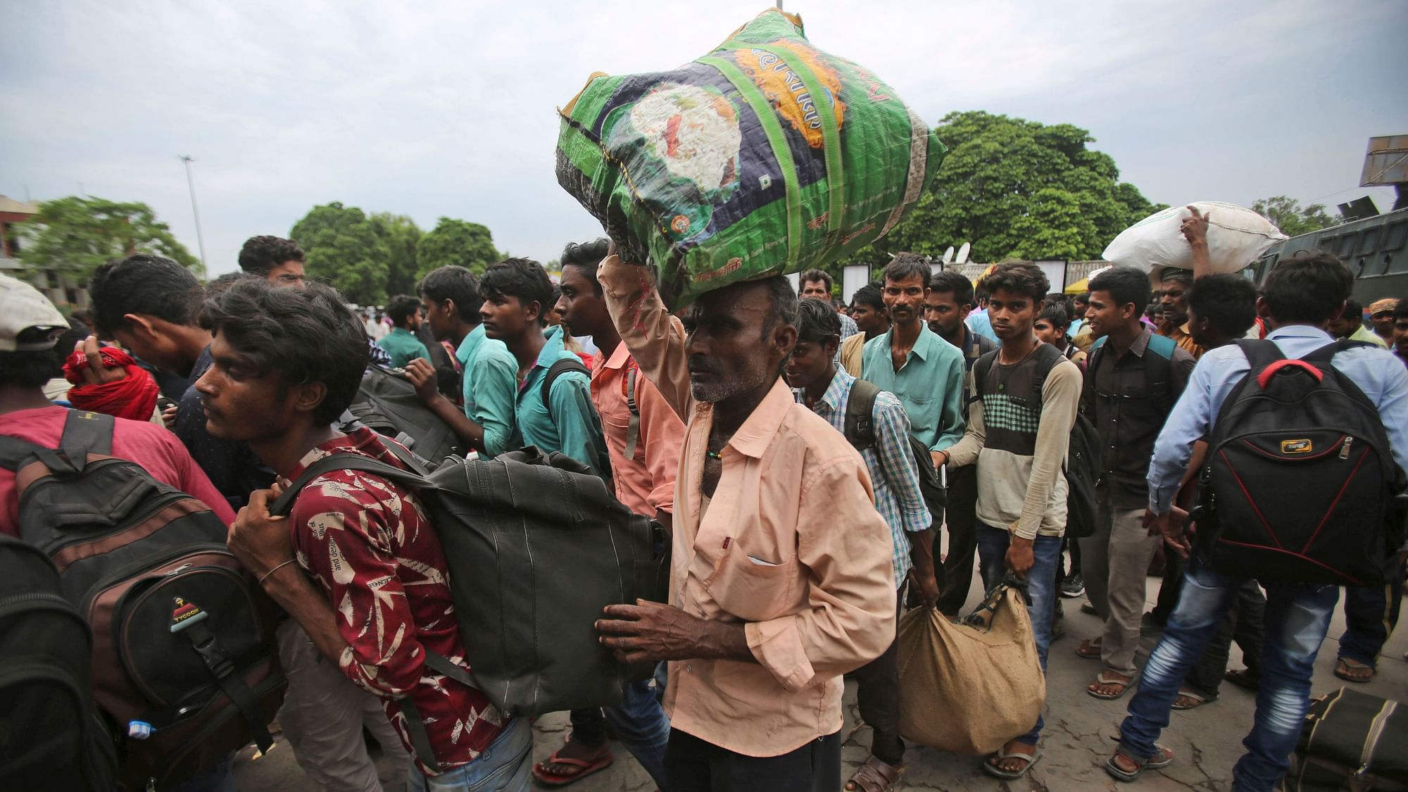 Indian migrant labourers carry their luggage and prepare to leave the region, at a railway station in Jammu. Image used for representational purposes.&nbsp;