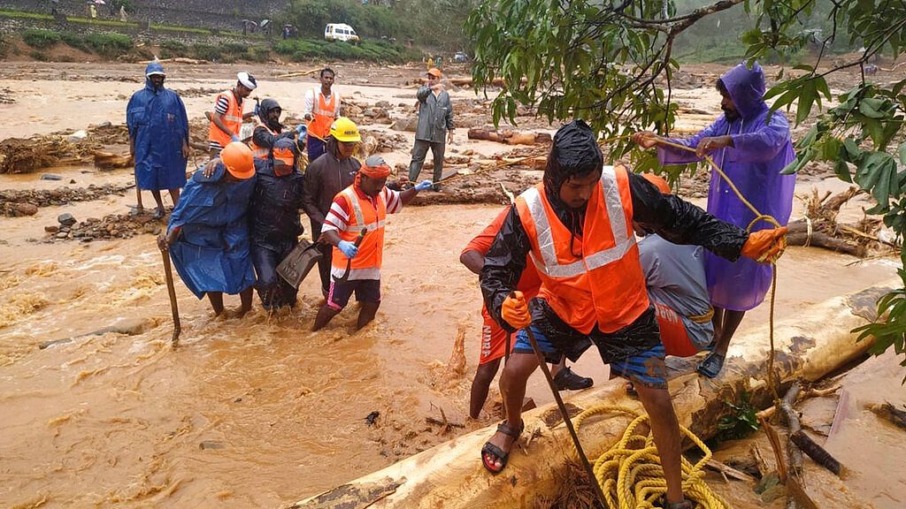 NDRF personnel help move flood victims to safer areas in Wayanad district of Kerala. &nbsp;