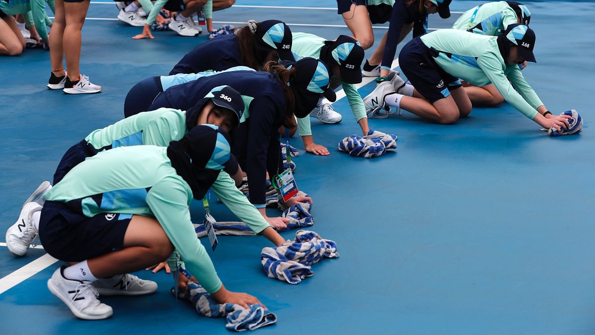 Melbourne Park staff used high-pressure hoses to clean court surfaces.