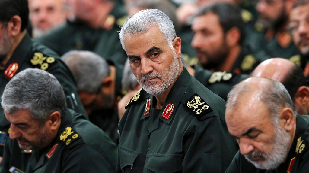 Iranian supreme leader, Revolutionary Guard Gen Qassem Soleimani, center, attends a meeting in Tehran