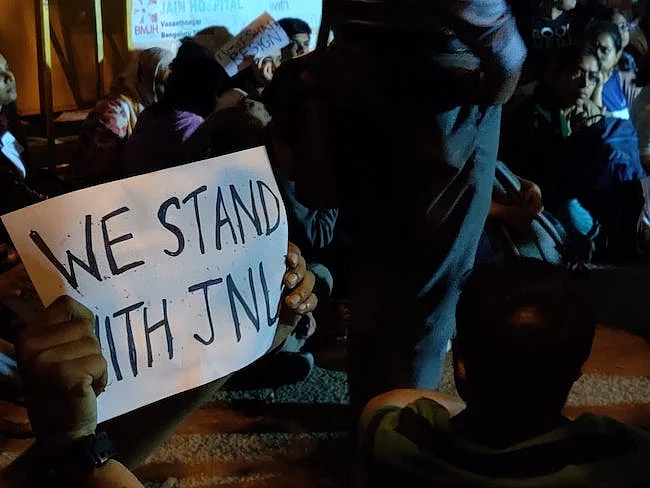 Protesters holding placards with slogans expressing solidarity with JNU students.