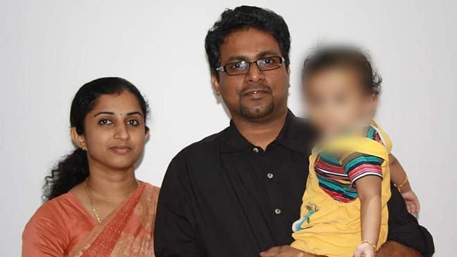 39-year-old Renjith Kumar TB with his wife, 34-year-old Indu Renjith, and their child.