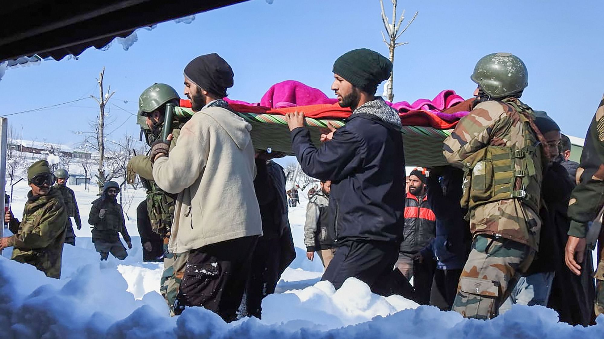 Chinar Corps personnel carry an expecting mother Shamima, who needed  emergency help, to hospital through heavy snow.&nbsp;