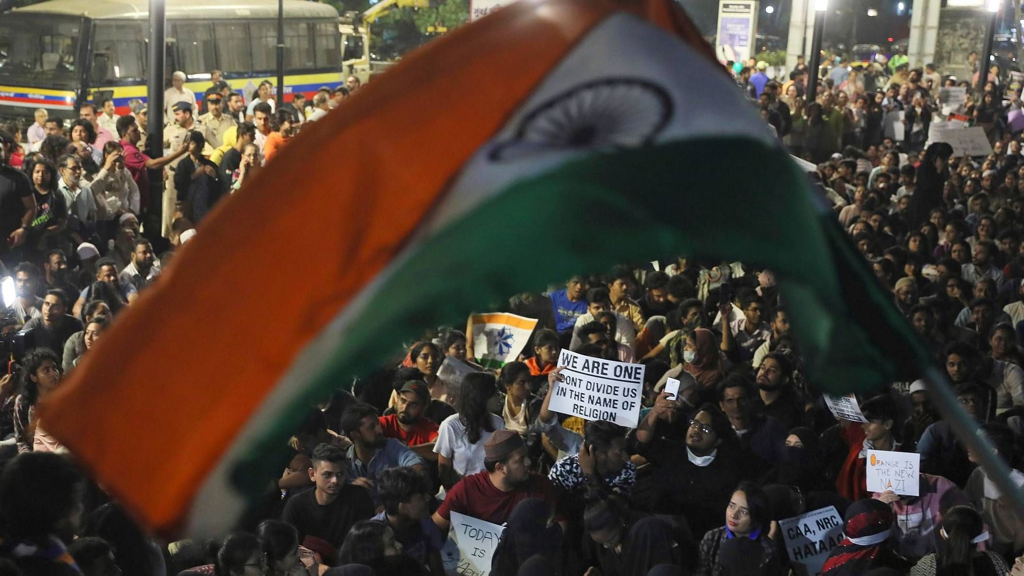 A protestor holds a national flag during a protest against a new citizenship law that opponents say threatens India’s secular identity in Mumbai, on Wednesday, 8 January.