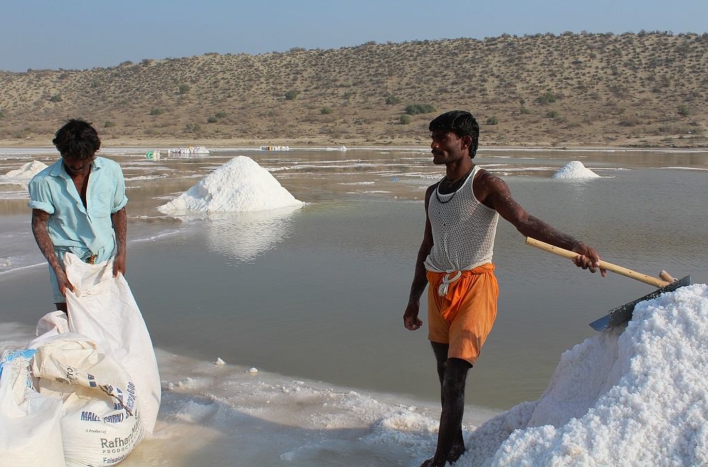 Labourers collecting salt from Achro Thar’s lakes in Pakistan’s  Sindh live in poverty & work in extreme conditions.