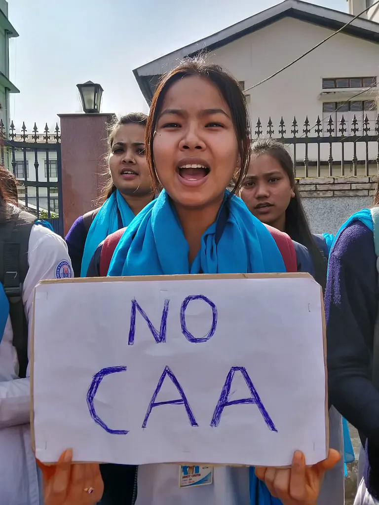 A college student in Tinsukia holding ‘No CAA’ placard