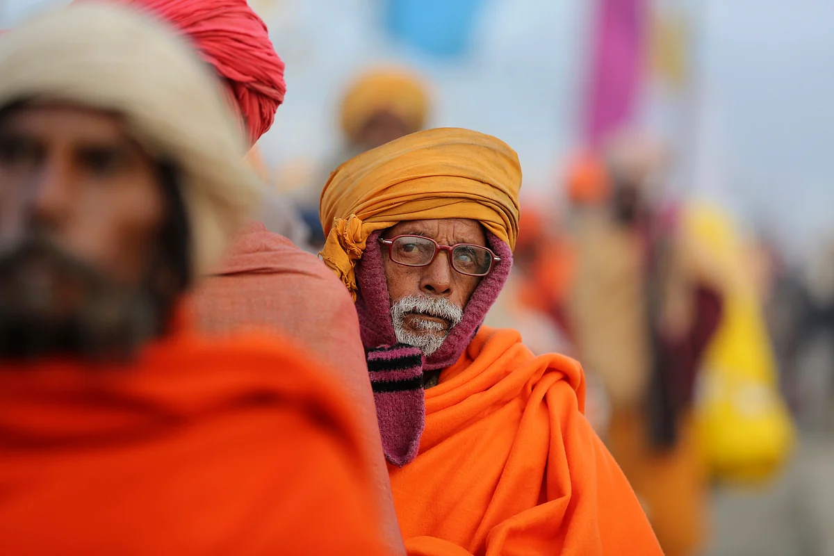 Devotees wait for a community feast on the banks of the Sangam, the meeting point of the Ganges and the Yamuna rivers, on the auspicious Paush Purnima day during the annual traditional Magh Mela fair in Prayagraj, on Friday, 10 January.