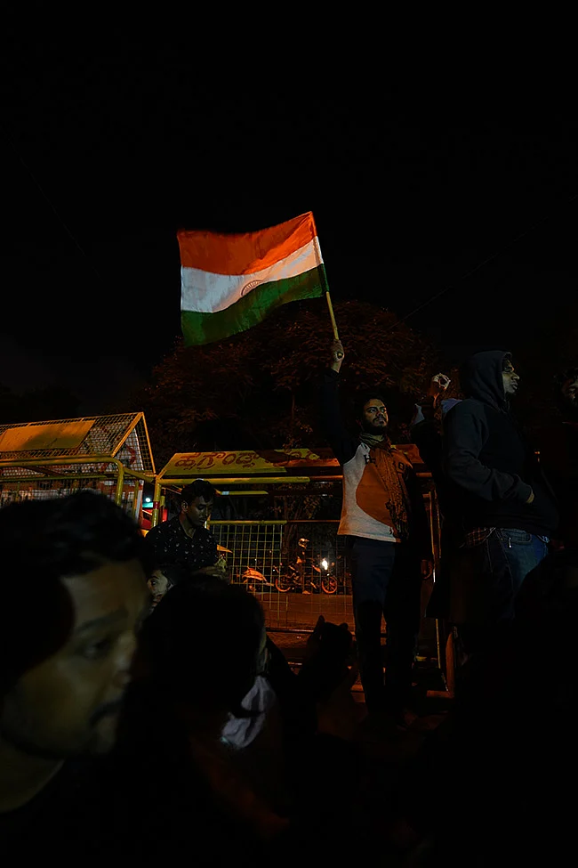 A protester waves the Indian flag during the demonstration at Bengaluru’s Maurya Circle.