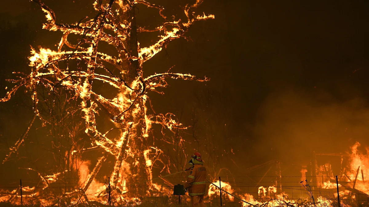 Rural Fire Service crew fight the Gospers Mountain Fire as it impacts a property at Bilpin, New South Wales state, Australia.