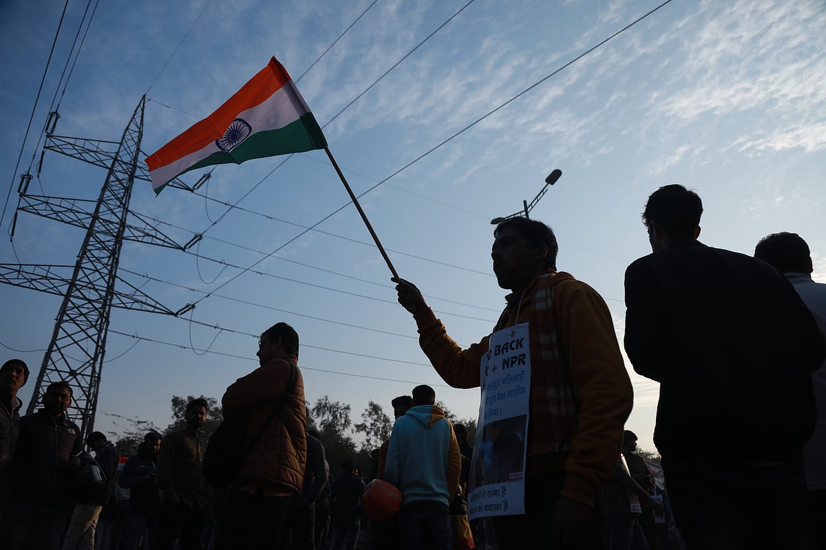 Anti-CAA protester waves the Indian flag at Shaheen Bagh protests.&nbsp;