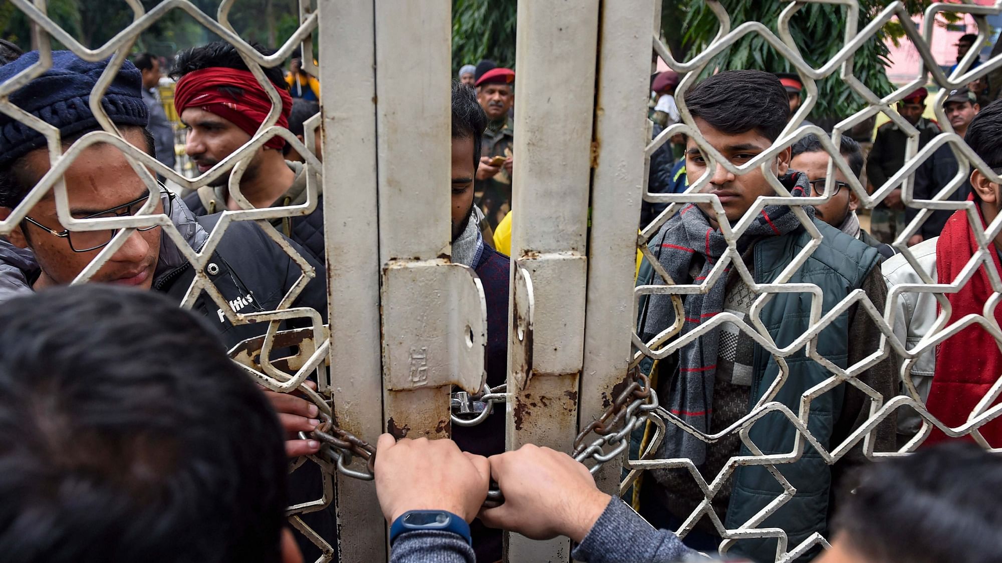 Jamia students try to break a lock to enter the vice chancellor’s office, demanding an FIR against the Delhi police’s use of force against students on 15 December 2019.