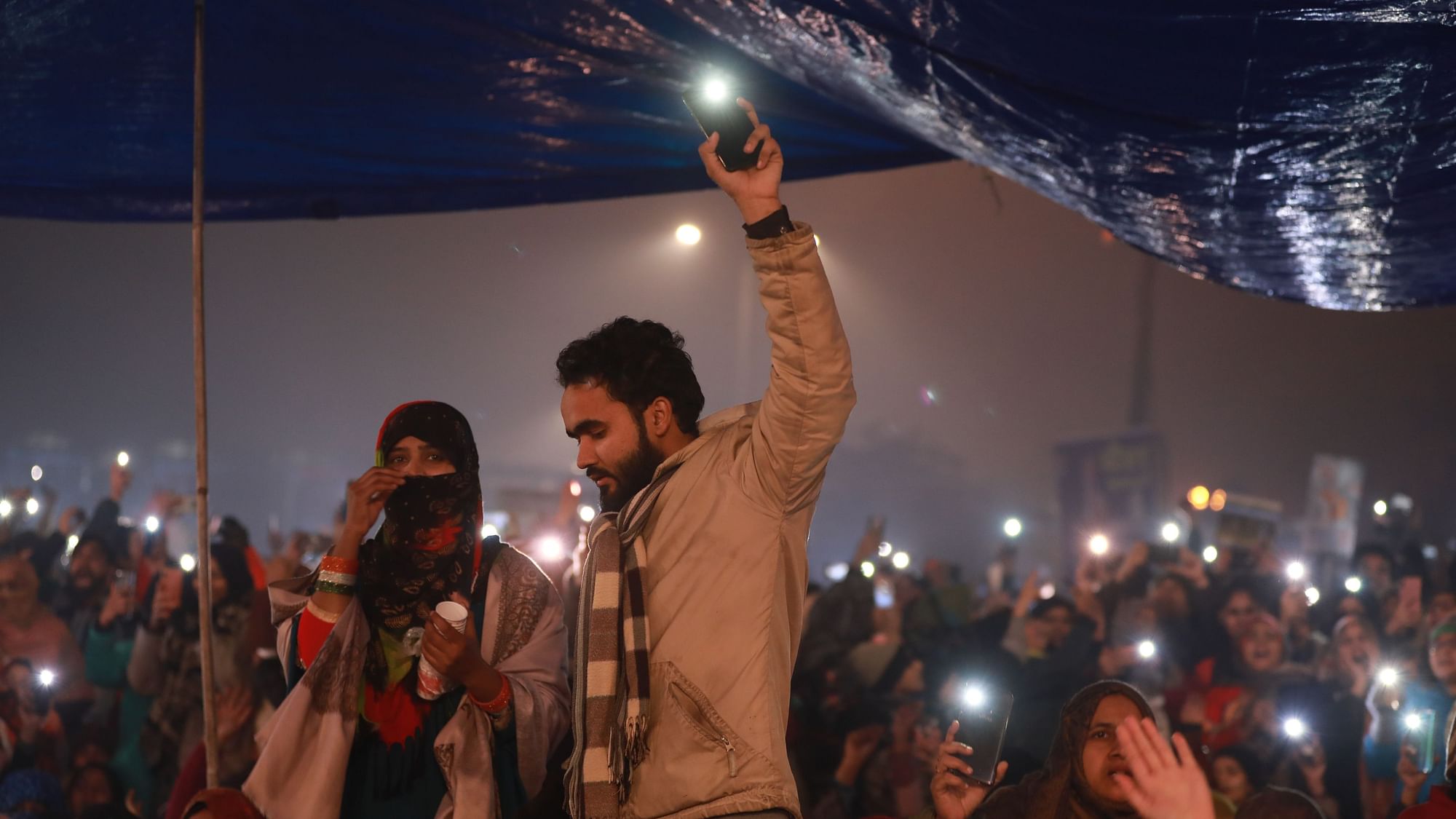 Protesters hold a mobile-torch demonstration at Shaheen Bagh.&nbsp;