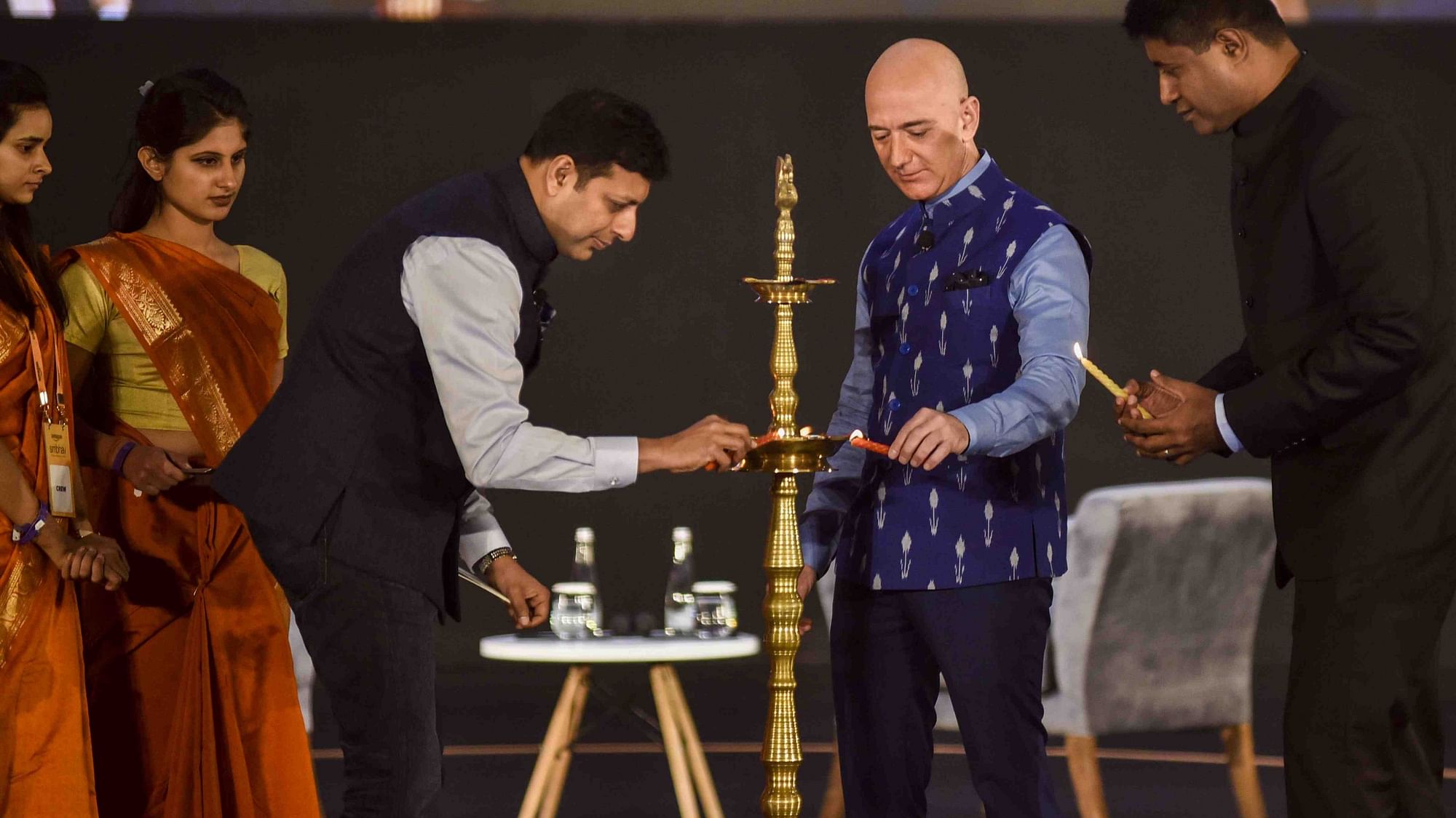 Amazon chief Jeff Bezos lights the ceremonial lamp with Amazon Global Senior Vice President Amit Agarwal during Amazon SMBhav summit in Delhi on 15 January.