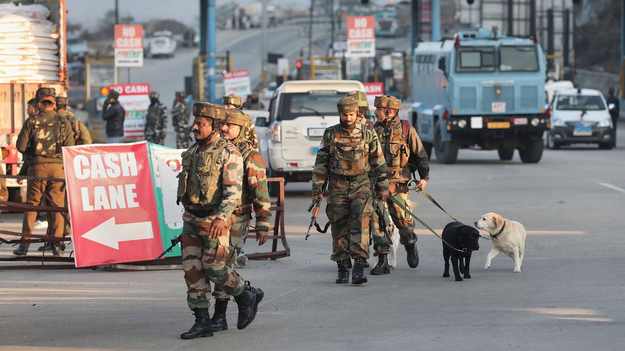 Security personnel along with their dogs inspect the site of encounter at Nagrota toll plaza.
