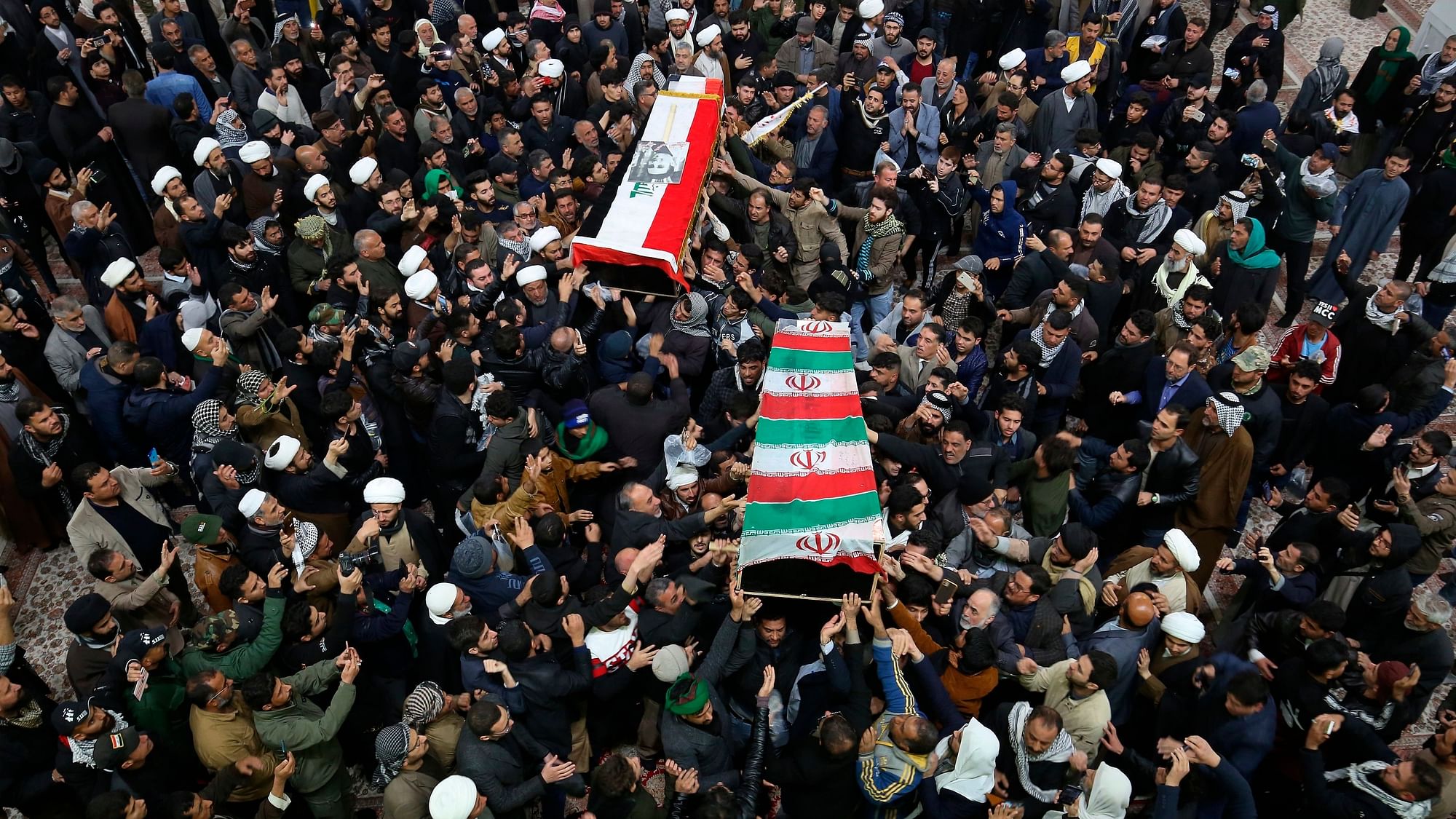 Mourners carry the coffins of Iran’s General Qassem Soleimani and Abu Mahdi al-Muhandis, deputy commander of Iran-backed militias, at the Imam Ali shrine in Najaf, Iraq, Saturday, 4 January, 2020.