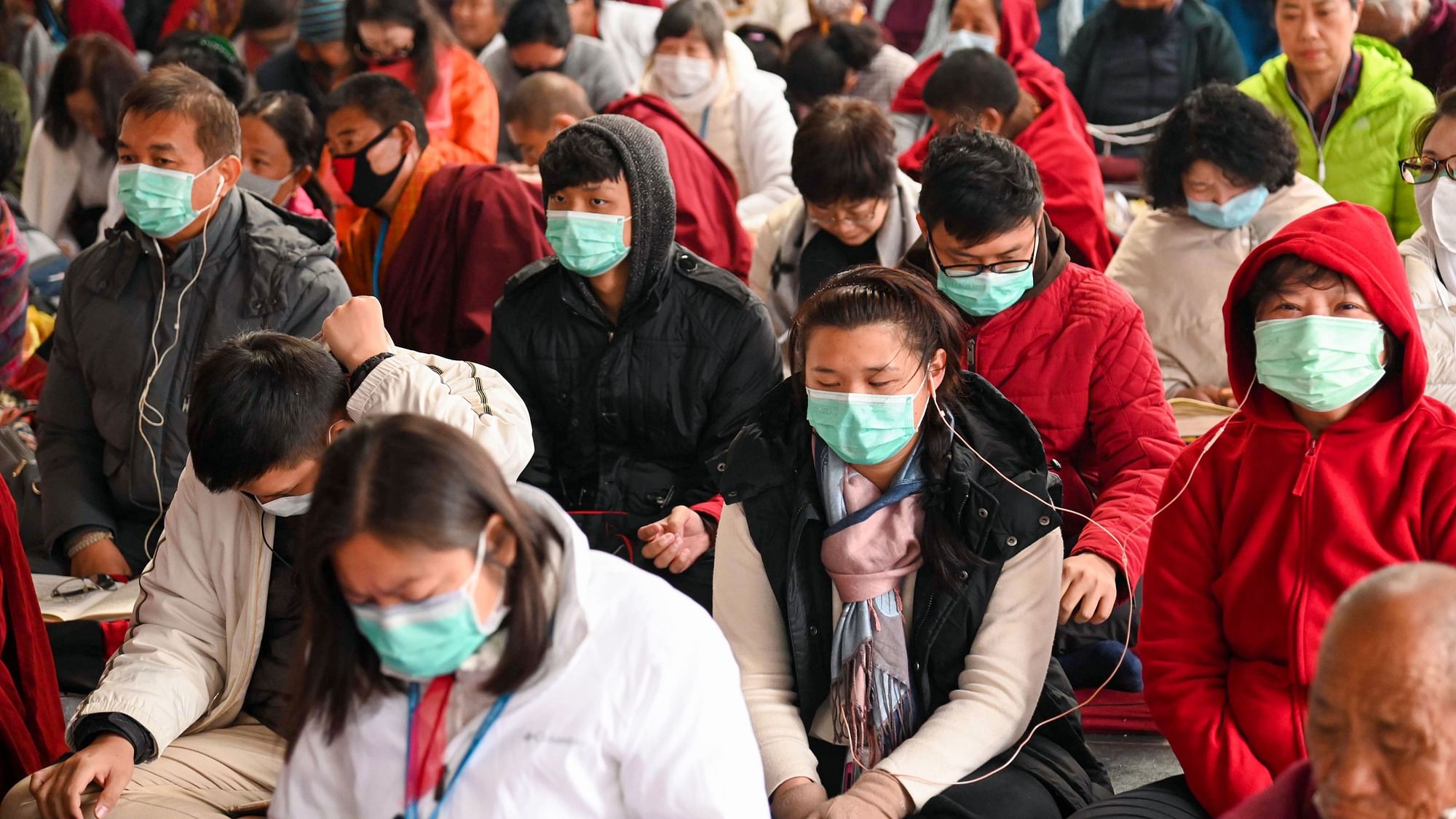 Devotees from Hong Kong and Taiwan, wearing masks as precaution against coronavirus, take part in the 37th Kagyu Monlam prayers in Bodh Gaya on Saturday, February 8, 2020.