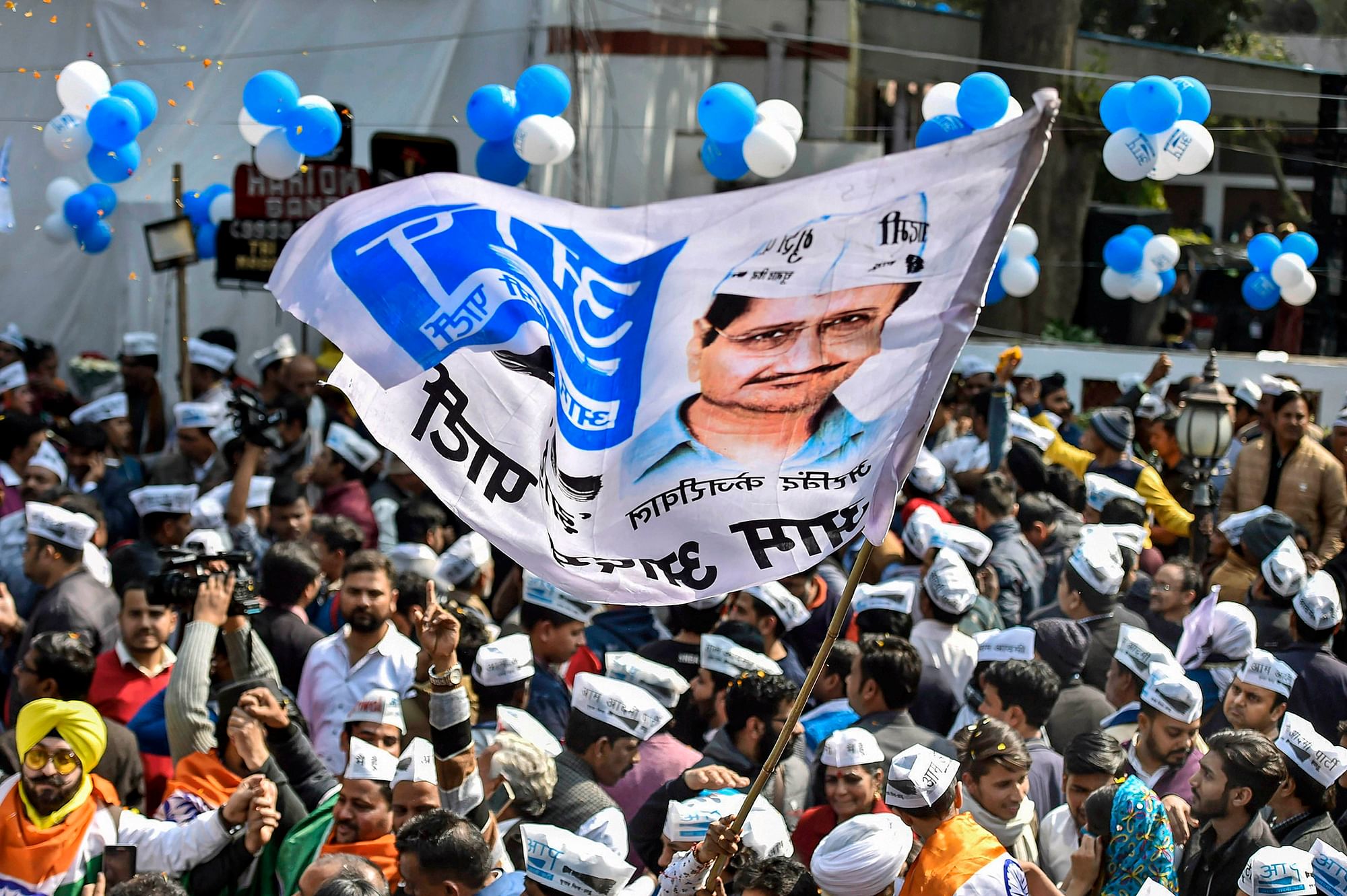 Aam Aadmi Party workers celebrate before the party’s victory in the Delhi Assembly polls, at party headquarters in New Delhi. 