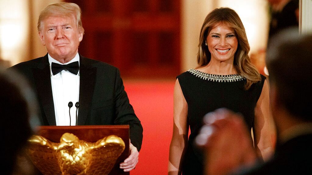 First Lady Melania Trump smiles next to US President Donald Trump as he arrives to speak at the Governors’ Ball on 9 February.