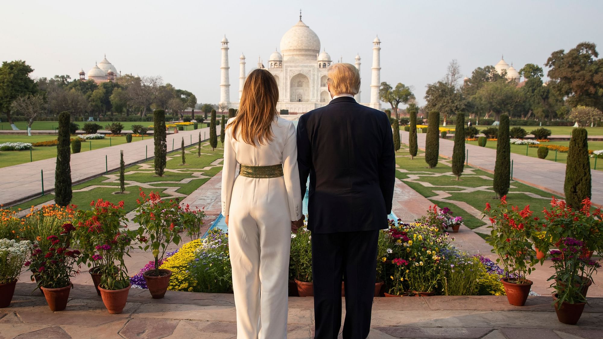US President Donald Trump, with first lady Melania Trump, pause as they tour the Taj Mahal, on Monday, 24 February, in Agra. 