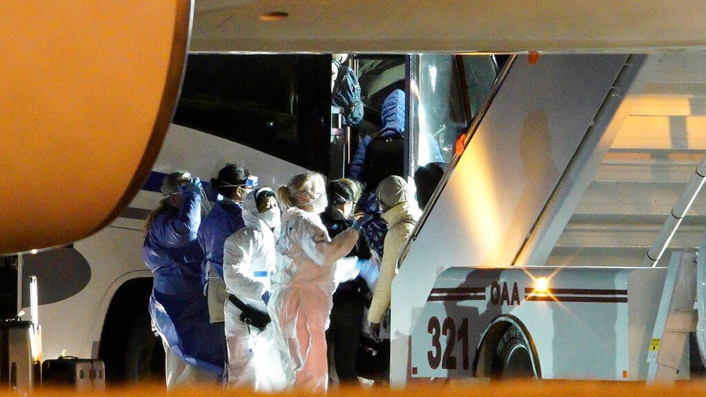 American evacuees from the coronavirus outbreak in China board a bus after arriving by flight to Eppley Airfield in Omaha, Neb., Friday, Feb. 7, 2020.