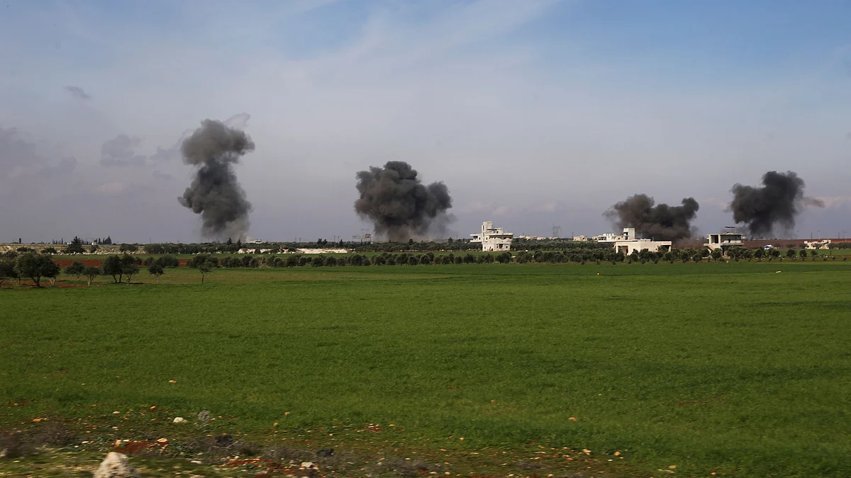 Columns of smoke raise after airstrikes hit town of Saraqeb, in Idlib province, Syria, Thursday, 27 February.
