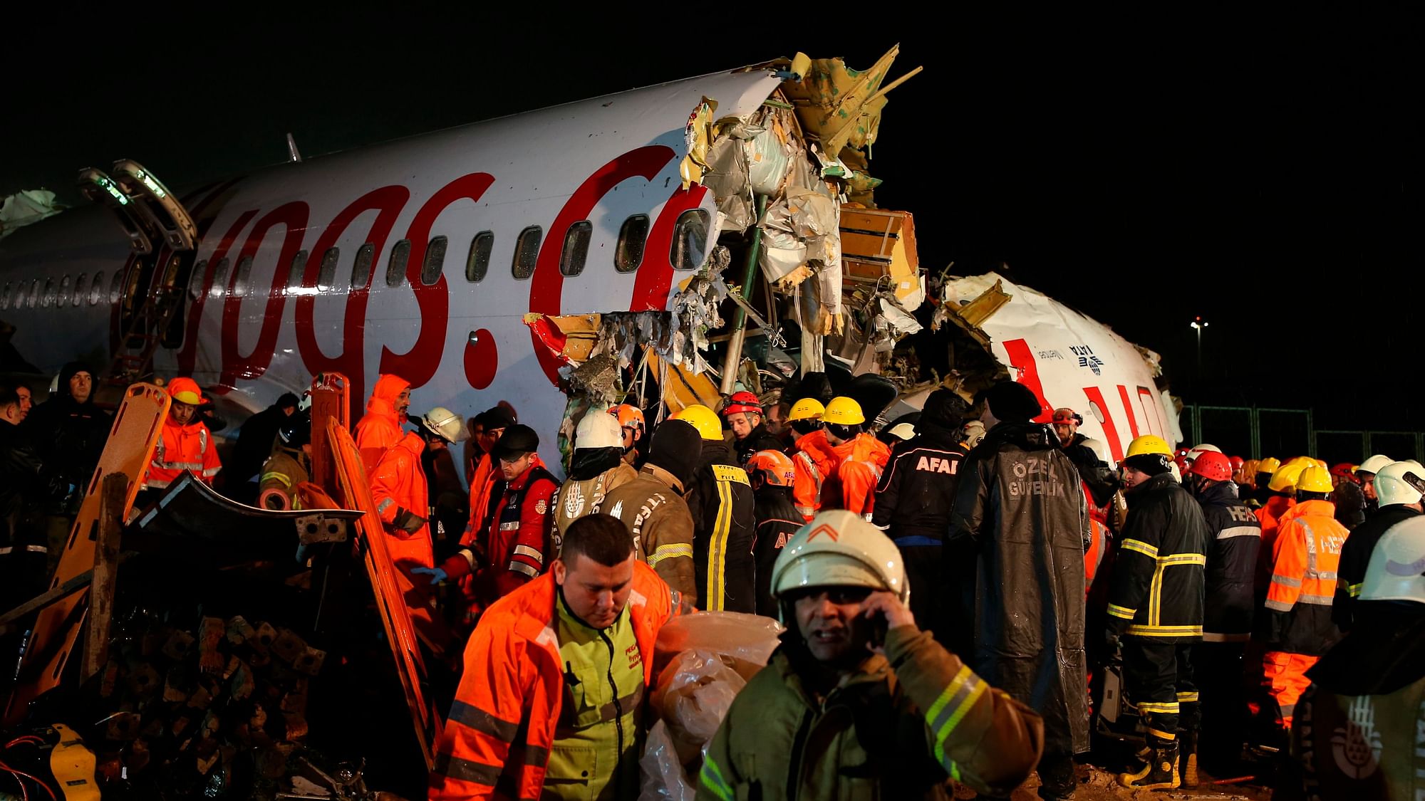 Rescue members and firefighters work after a plane skidded off the runway at Istanbul’s Sabiha Gokcen Airport, in Istanbul.&nbsp;