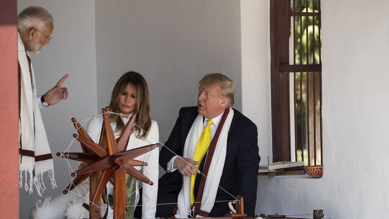US President Donald Trump, with first lady Melania Trump, and Indian Prime Minister Narendra Modi, look at a Charkha, or a spinning wheel, during a tour of Gandhi Ashram in Ahmedabad.