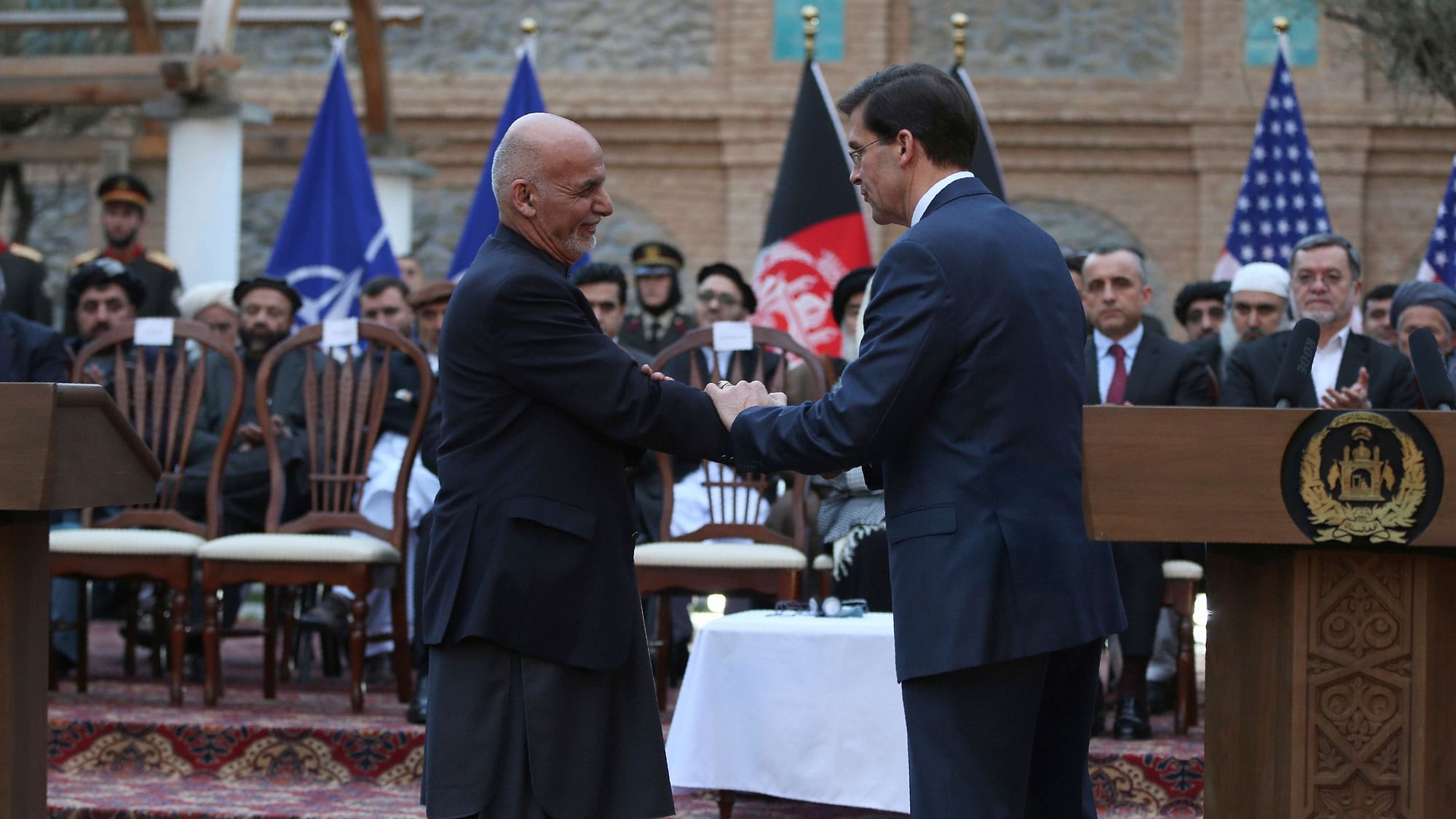 Afghan President Ashraf Ghani shakes hands with US Secretary of Defense Mark Esper after a joint news conference in presidential palace in Kabul on 29 February.&nbsp;