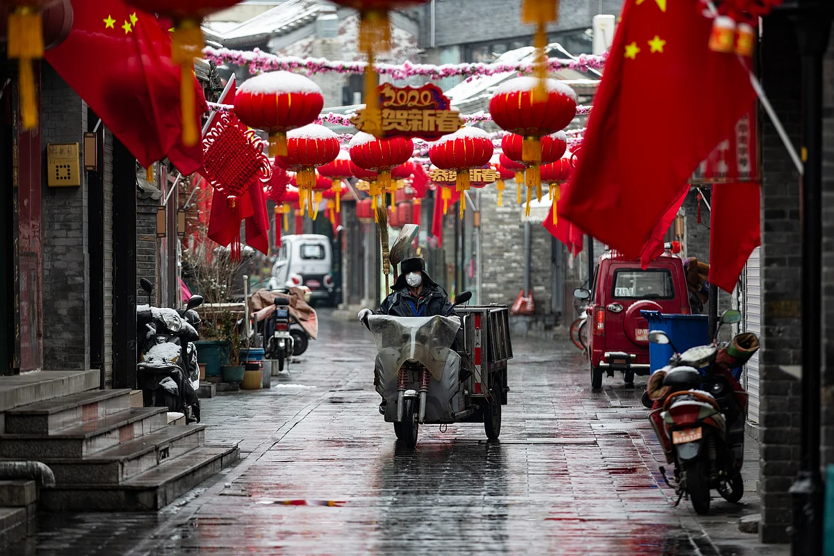Red lanterns, national flags and other auspicious decorations are hung upon houses in a lane in Beijing. Local residents, who have rarely gone outdoors these days because of the outbreak of novel coronavirus, celebrate Chinese New Year.