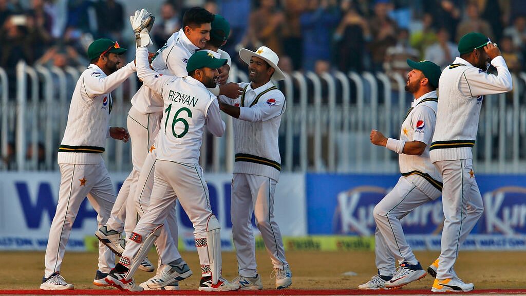 Pakistan players celebrate the fall of a Bangladesh wicket in the first Test of the two-match series.