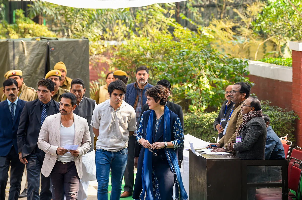 Congress general secretary Priyanka Gandhi Vadra along with her husband Robert Vadra and son Raihan Vadra, who is a first-time voter, arrive to cast their vote during the Delhi Assembly elections at a polling station, in Lodhi Estate area of New Delhi, Saturday, 8 February.