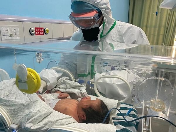 Zeng Lingkong, director of Wuhan Children&apos;s Hospital&apos;s neonatology Department, checks the condition of an infant in this file photo.