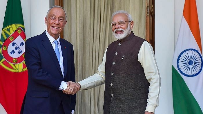 Prime Minister Narendra Modi (R) shakes hands with Portuguese President Marcelo Rebelo de Sousa prior to a meeting at Hyderabad House, in New Delhi, Friday, 14 February.