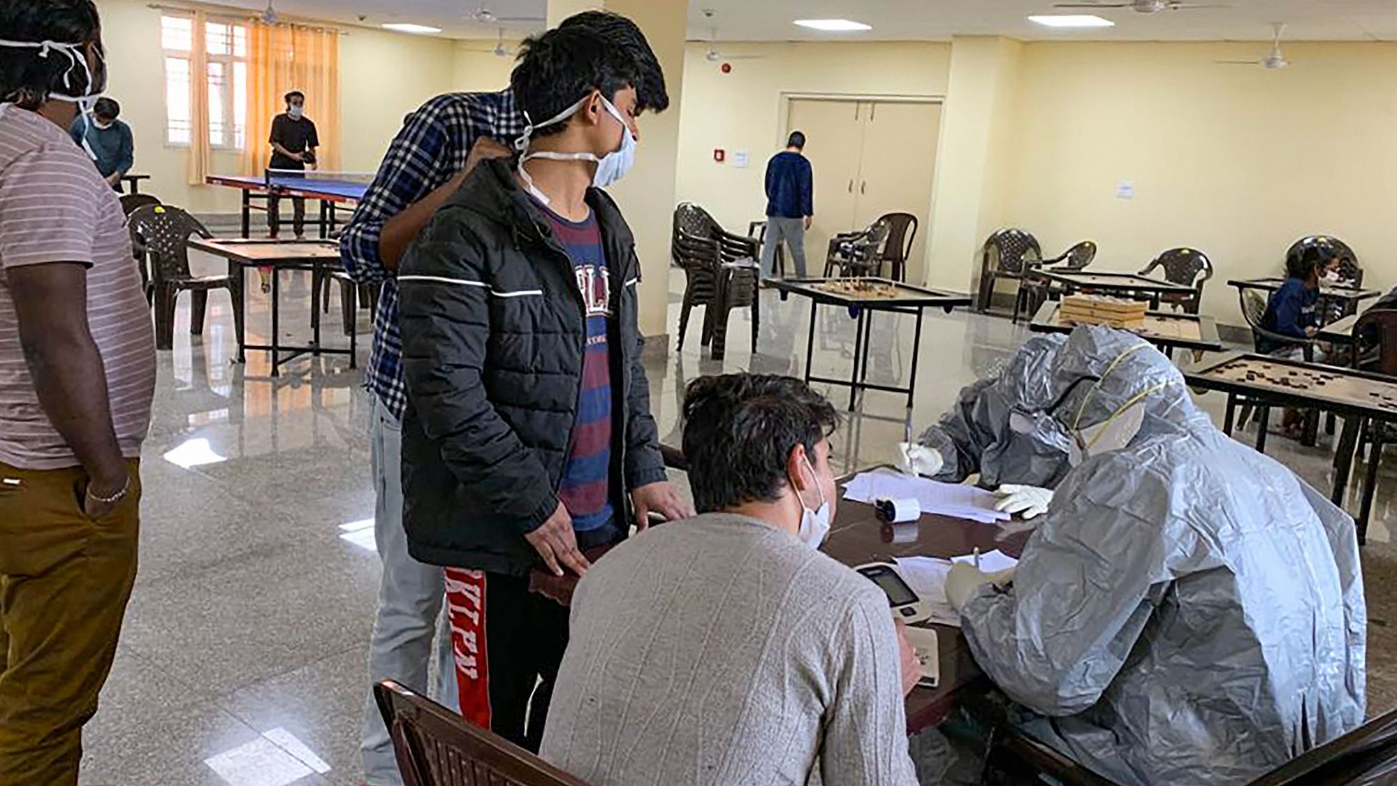 In this handout photo provided by Indo-Tibetan Border Police , Indian nationals who were airlifted from coronavirus-hit Hubei province of Chinas Wuhan, undergo screening at a quarantine facility set by up ITBP, at Chhawla area in New Delhi, Saturday, Feb. 15, 2020.