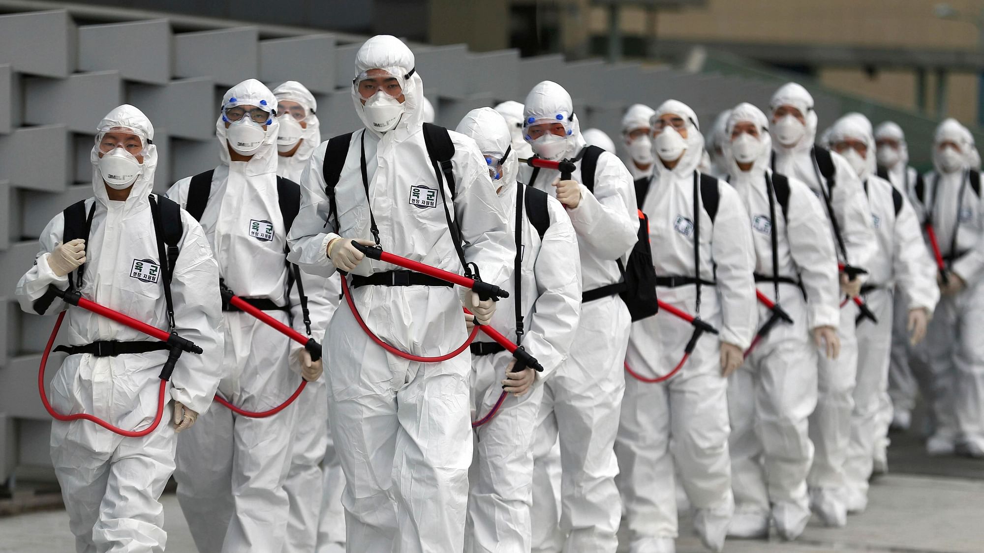 South Korean Army soldiers wearing protective gear gather to spray disinfectant to prevent the spread of the novelcoronavirus at the Dongdaegu train station in Daegu, South Korea, Saturday, 29 Feb 2020.