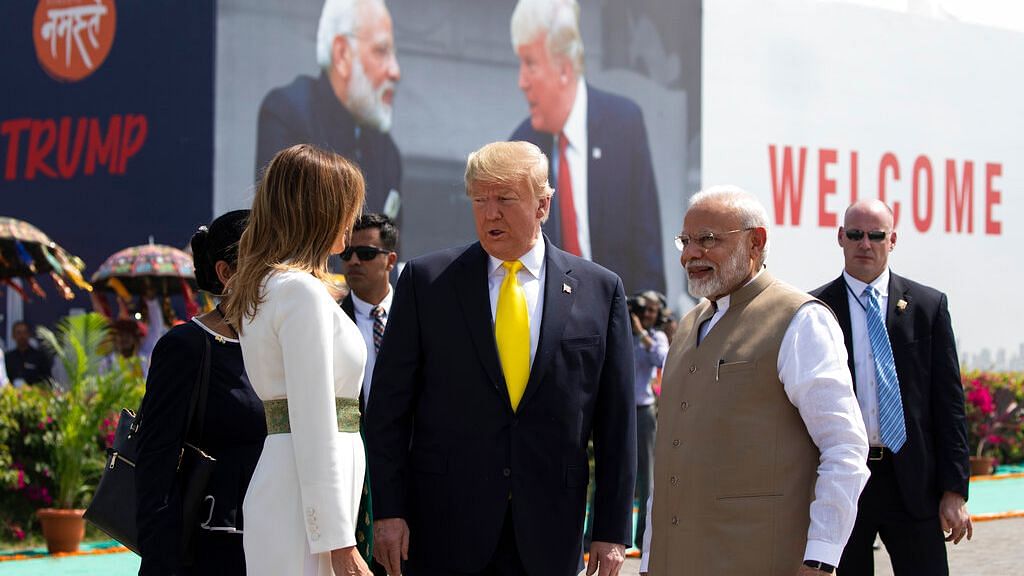 US President Donald Trump speaks with first lady Melania Trump, with Indian Prime Minister Narendra Modi by his side, upon arrival at Sardar Vallabhbhai Patel International Airport in Ahmedabad.