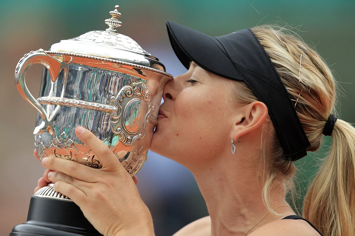 In this June 9, 2012, file photo, Maria Sharapova of Russia holds the trophy after winning the women’s final match against Sara Errani of Italy at the French Open tennis tournament at Roland Garros stadium in Paris. 