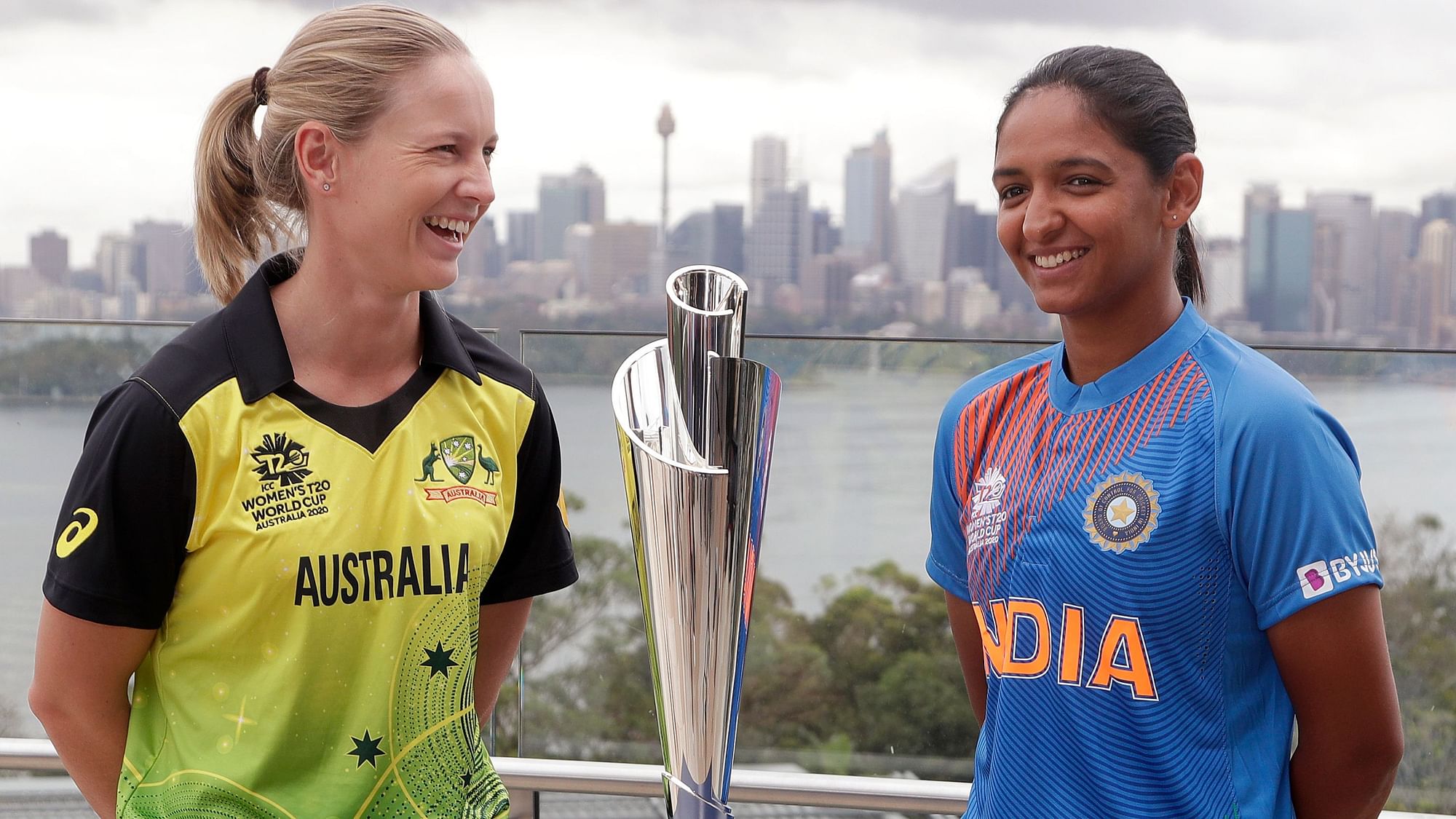 Captains Meg Lanning of Australia and  Harmanpreet Kaur of India pose for a photo with the trophy ahead of the Women’s T20 World Cup in Sydney.