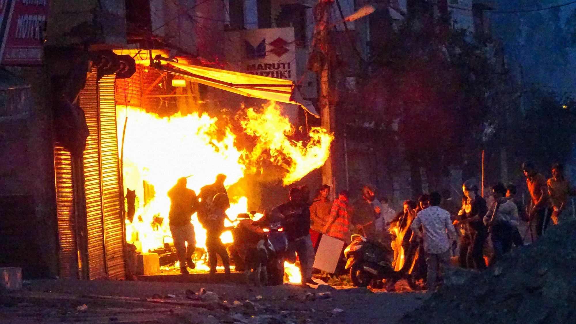  Rioters set ablaze a shop during clashes between those against and those supporting the Citizenship (Amendment) Act in at Gokalpuri in northeast Delhi.