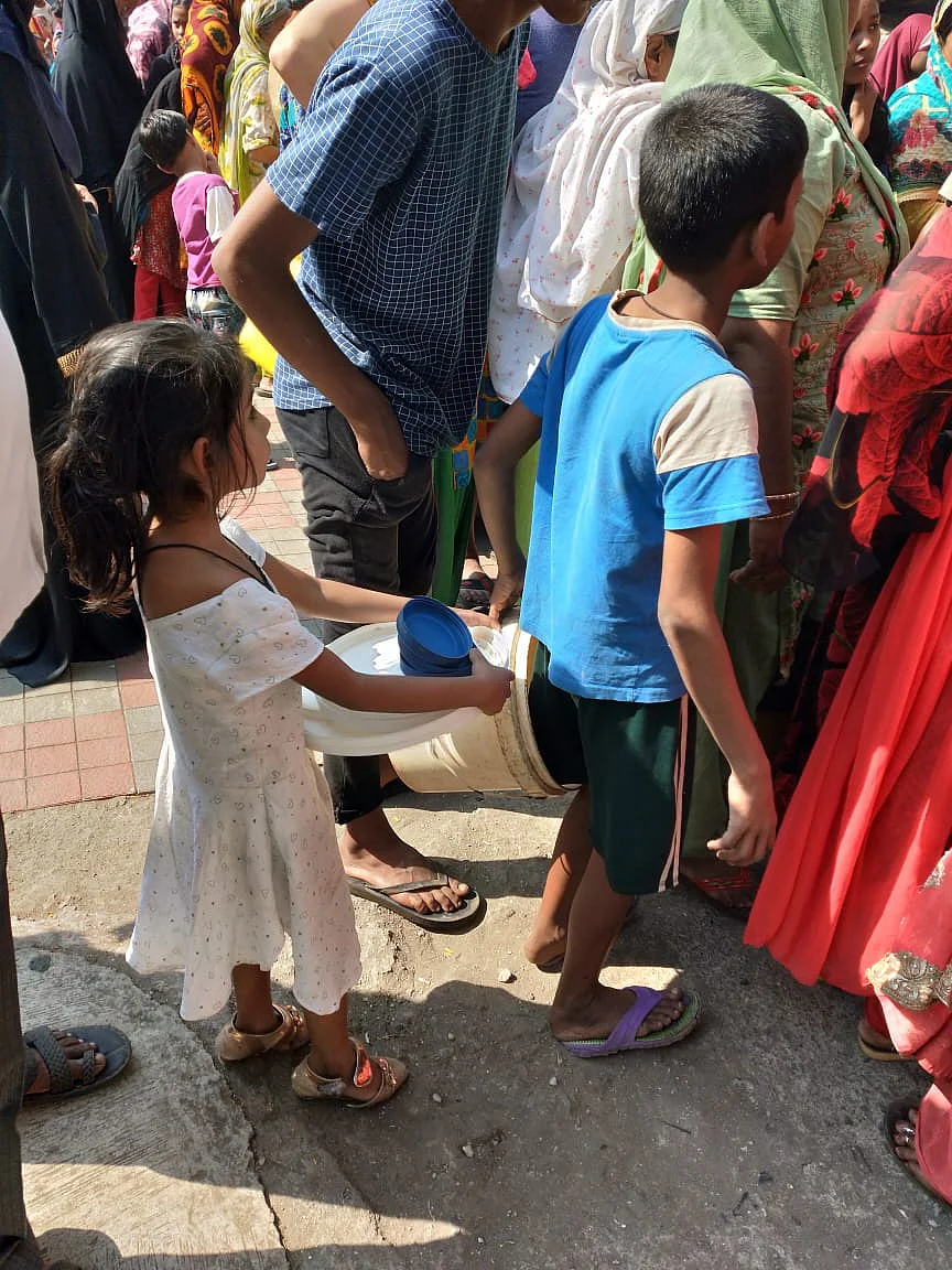 Even children are lining up to get water.