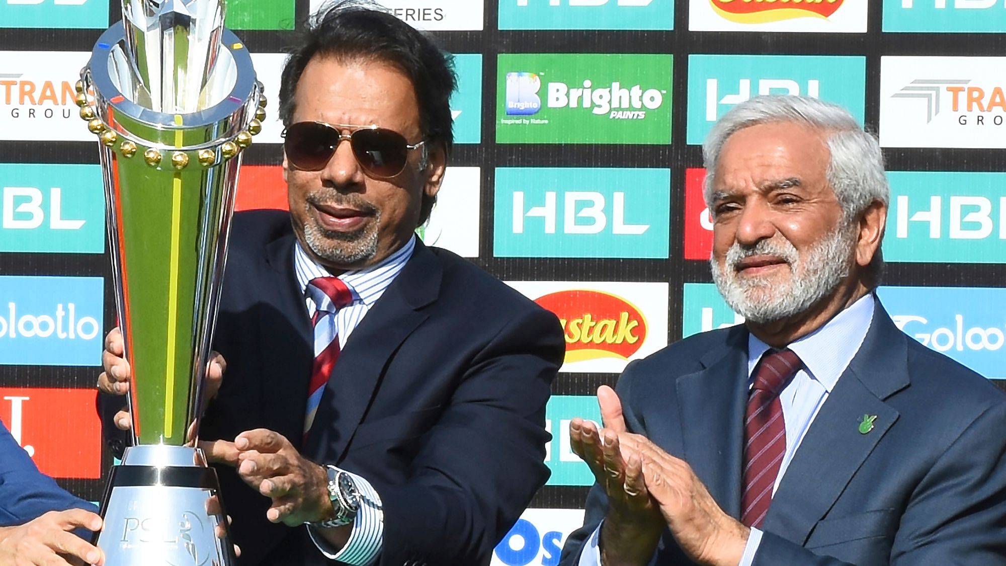 Pakistan’s former squash world champion Jahangir Khan unveils the PSL trophy at the National Stadium in Karachi, Pakistan with Chief of Pakistan Cricket Board Ehsan Mani, right, Wednesday, Feb. 19, 2020.