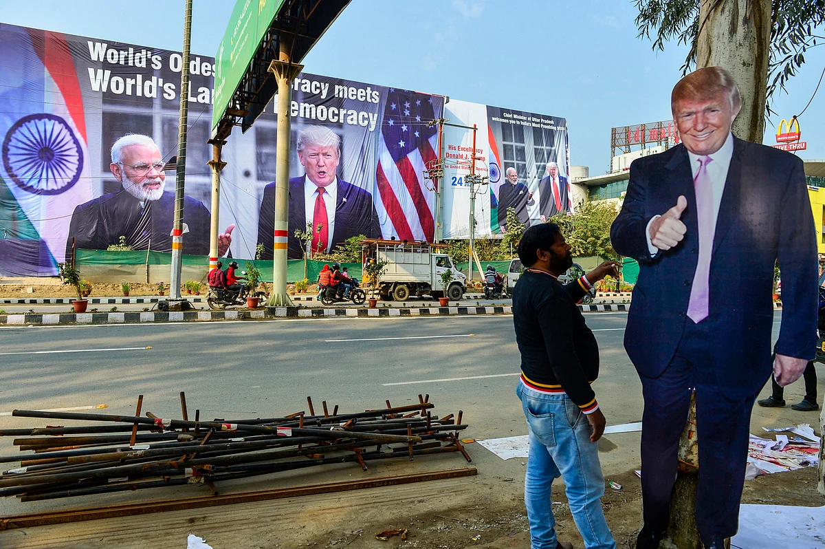 A worker arranges billboards of U.S President Donald Trump, near Taj Mahal ahead of US President Donald Trump’s maiden visit to India, in Agra.