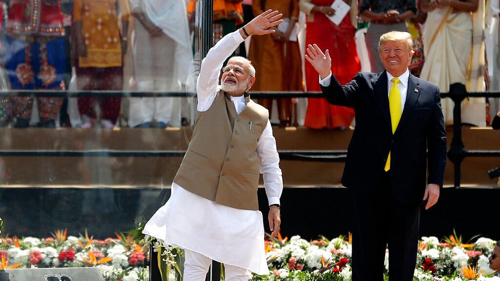 U.S. President Donald Trump and Indian Prime Minister Narendra Modi wave to the crowd at Sardar Patel Stadium in Ahmedabad, India, Monday, Feb. 24, 2020.