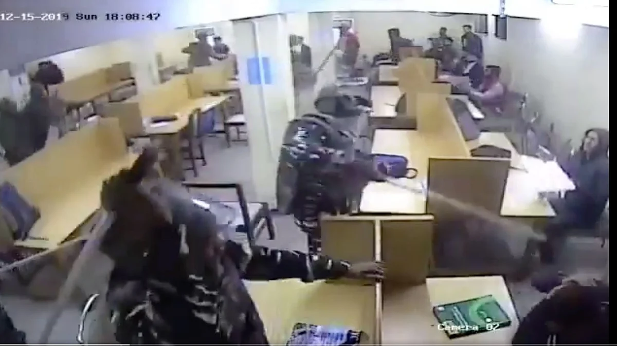 The video shows armed policemen entering a hall and thrashing students who were purportedly studying there.