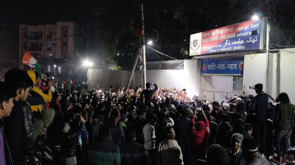 Students of Jamia Millia Islamia University and others gather outside Jamia Nagar Police station after a firing took place at Gate No 5 of Jamia University late Sunday, 2 February.