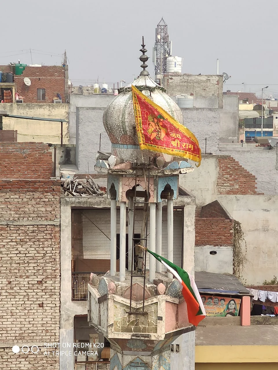 A saffron flag can clearly be seen on the minaret of the Mosque in Ashok Nagar, on Wednesday.