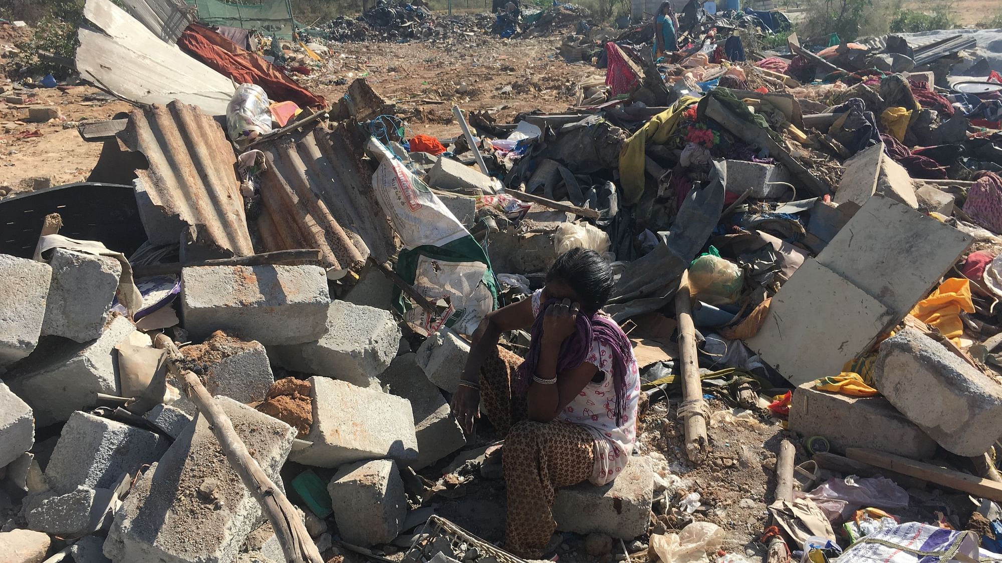 Sabina, 45, sits amid the rubble of her home in Munnekola near Marathahalli, in east Bengaluru.
