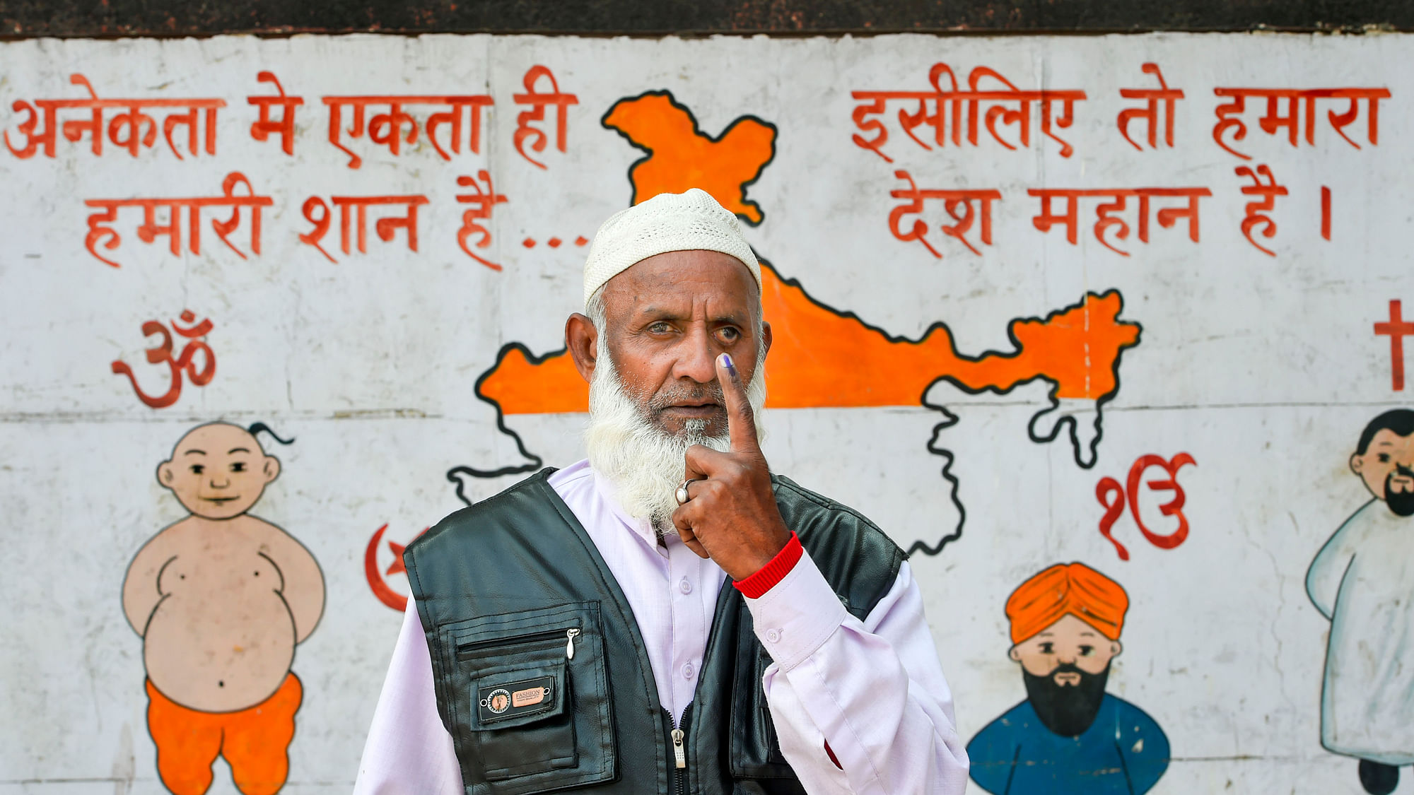 A voter shows his finger marked with indelible ink after casting vote during the Delhi Assembly elections at a polling station, in Old Delhi, Saturday, 8 February.&nbsp;