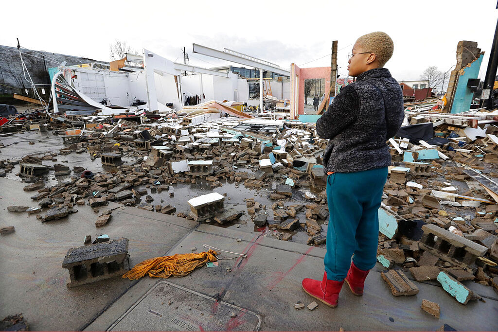 Faith Patton looks over buildings destroyed by storms Tuesday, 3 March, 2020, in Nashville, Tennessee.